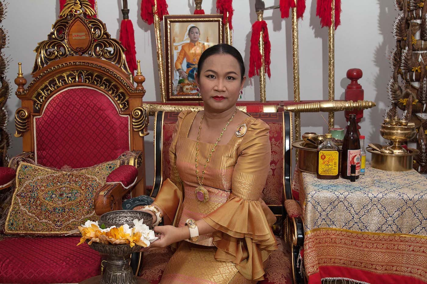 "Prem, a transgender woman, who may be possessed by seven different spirits, is one of the most respected maa khii (spirit mediums) in Thailand. People come to see her for spiritual counseling, healing, or good fortune through the intercession of the spirits that possess her." (© Mariette Pathy Allen, from <em>Transcendents: Spirit Mediums in Burma and Thailand</em>, courtesy Daylight Books)