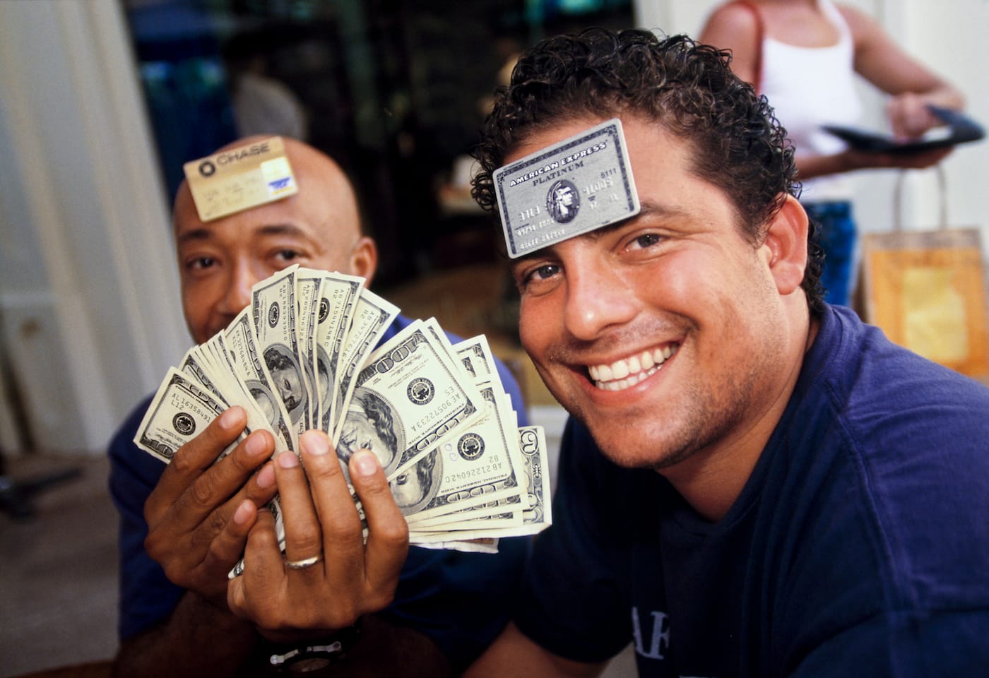 Film director and producer Brett Ratner (right), 29, and Russell Simmons, 41, a businessman and cofounder of hip-hop label Def Jam, at L’Iguane restaurant, St. Barts, 1998. Few establishments on the island accepted credit cards, and visitors often carried large amounts of cash. (© Lauren Greenfield, image from the Annenberg Space for Photography exhibition, <em/>Generation Wealth by Lauren Greenfield)