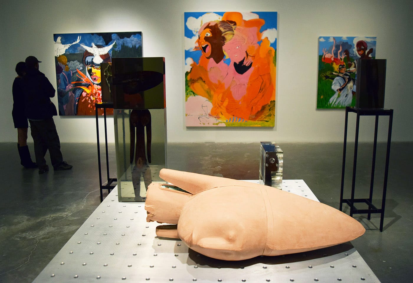 Installation view of <em>Songs for Sabotage</em> with sculptures by Matthew Angelo Harrison in the foreground and paintings by Janiva Ellis in the background