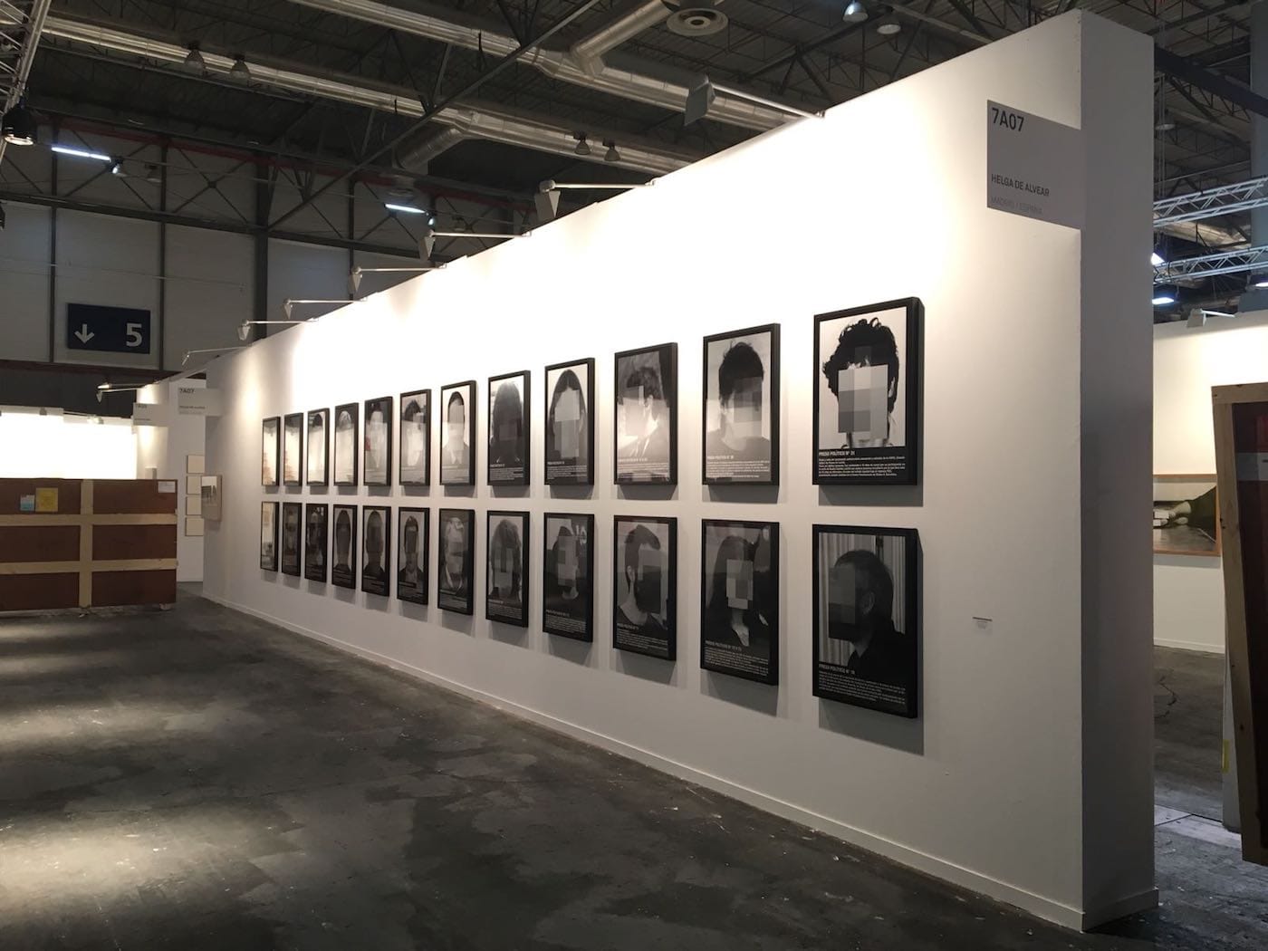Santiago Sierra, "Political Prisoners in Contemporary Spain" (2018) on view at the Helga de Alvear booth during the installation of Madrid's ARCO art fair (courtesy the artist and Helga de Alvear)