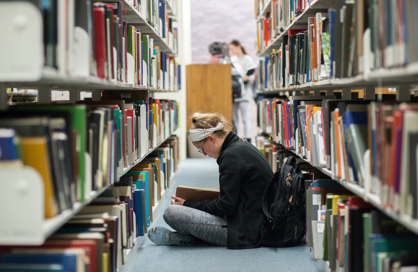 A student in the stacks of the Fine Arts Library at the University of Texas, Austin (courtesy University of Texas Libraries, the University of Texas at Austin)