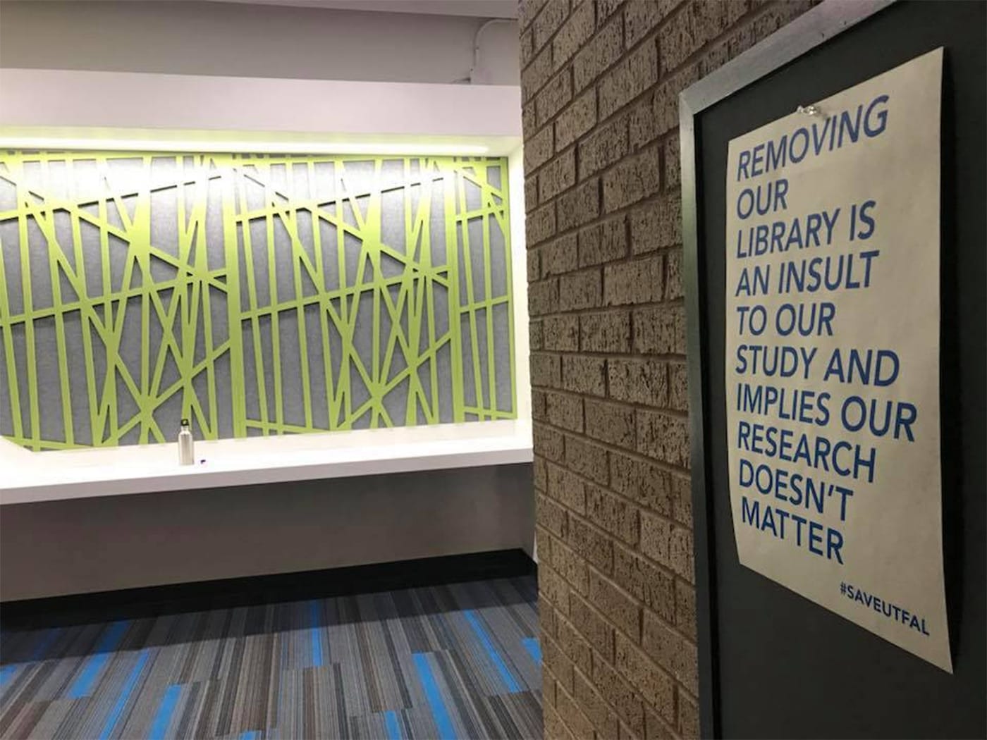 A poster protesting the downsizing of UT-Austin’s Fine Arts Library in the E. William Doty Fine Arts Building (photo by and courtesy Abigail Sharp)