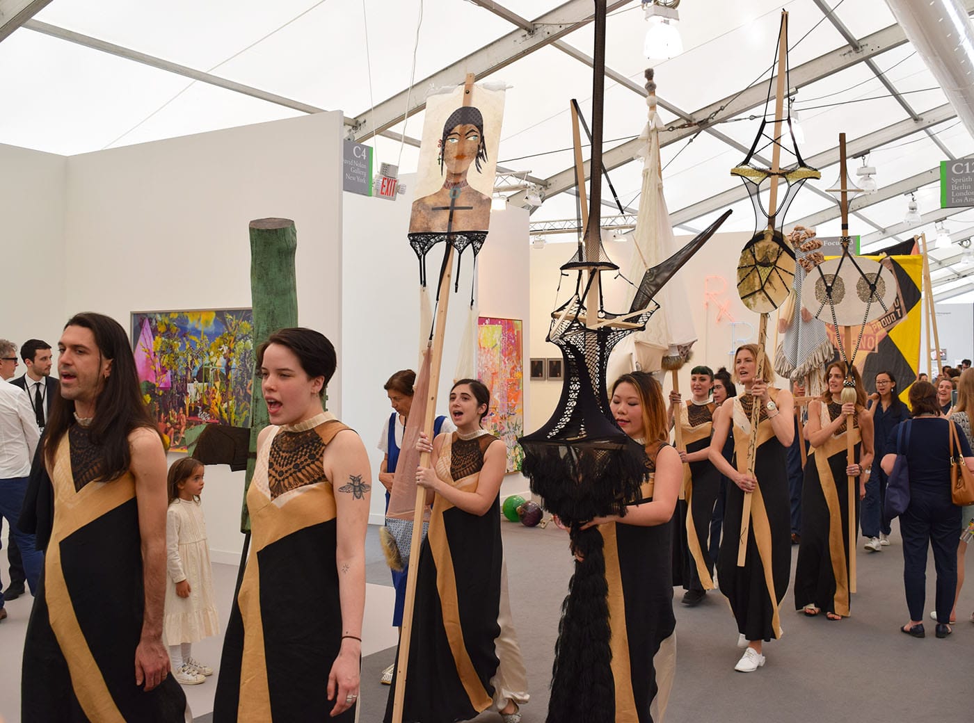 Lara Schnitger's "Sufragette City" procession winding its way through the aisles at Frieze New York