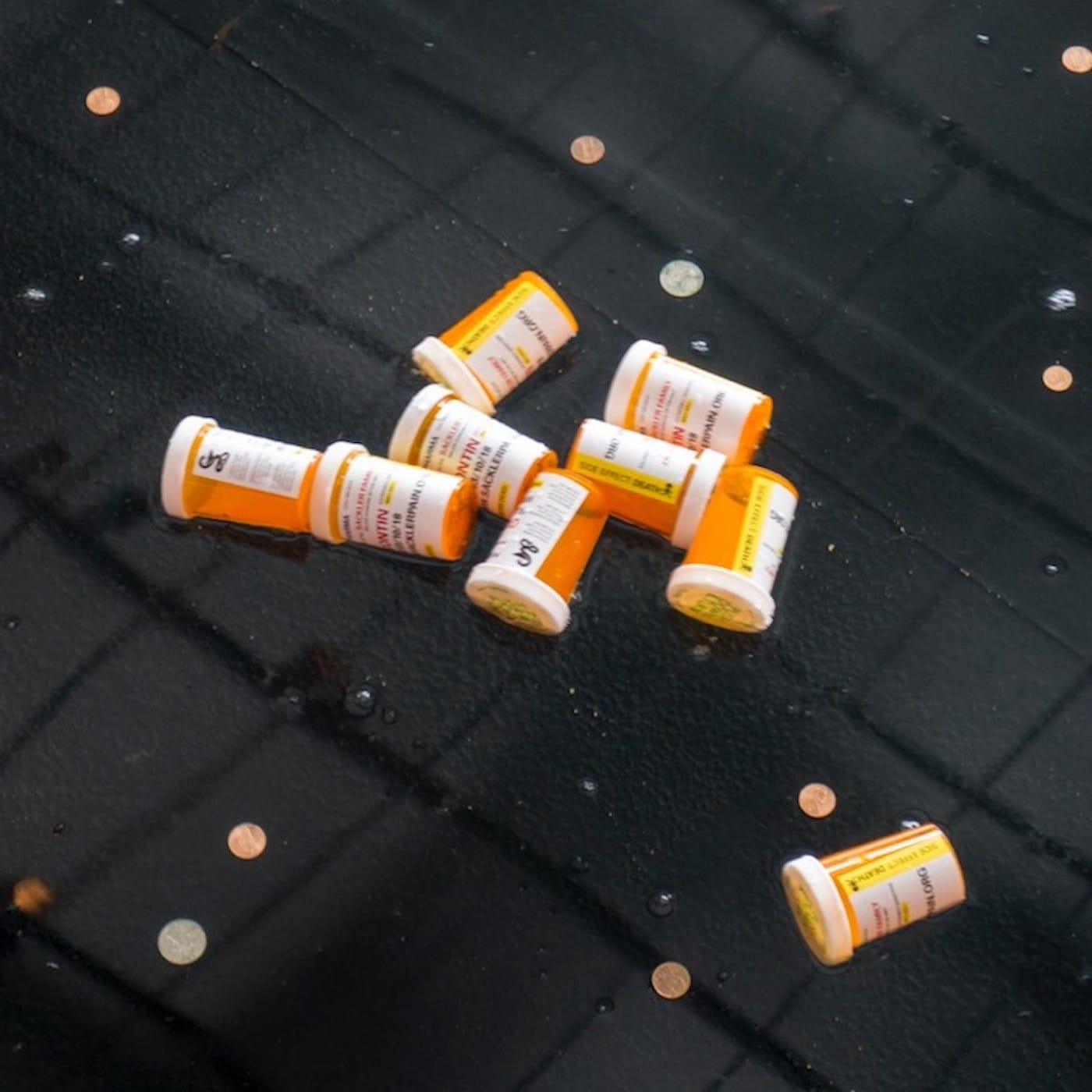 Sackler-branded pill bottles in the Sackler Wing’s reflecting pool at the Metropolitan Museum during a protest in March (photo by Tim Davis)