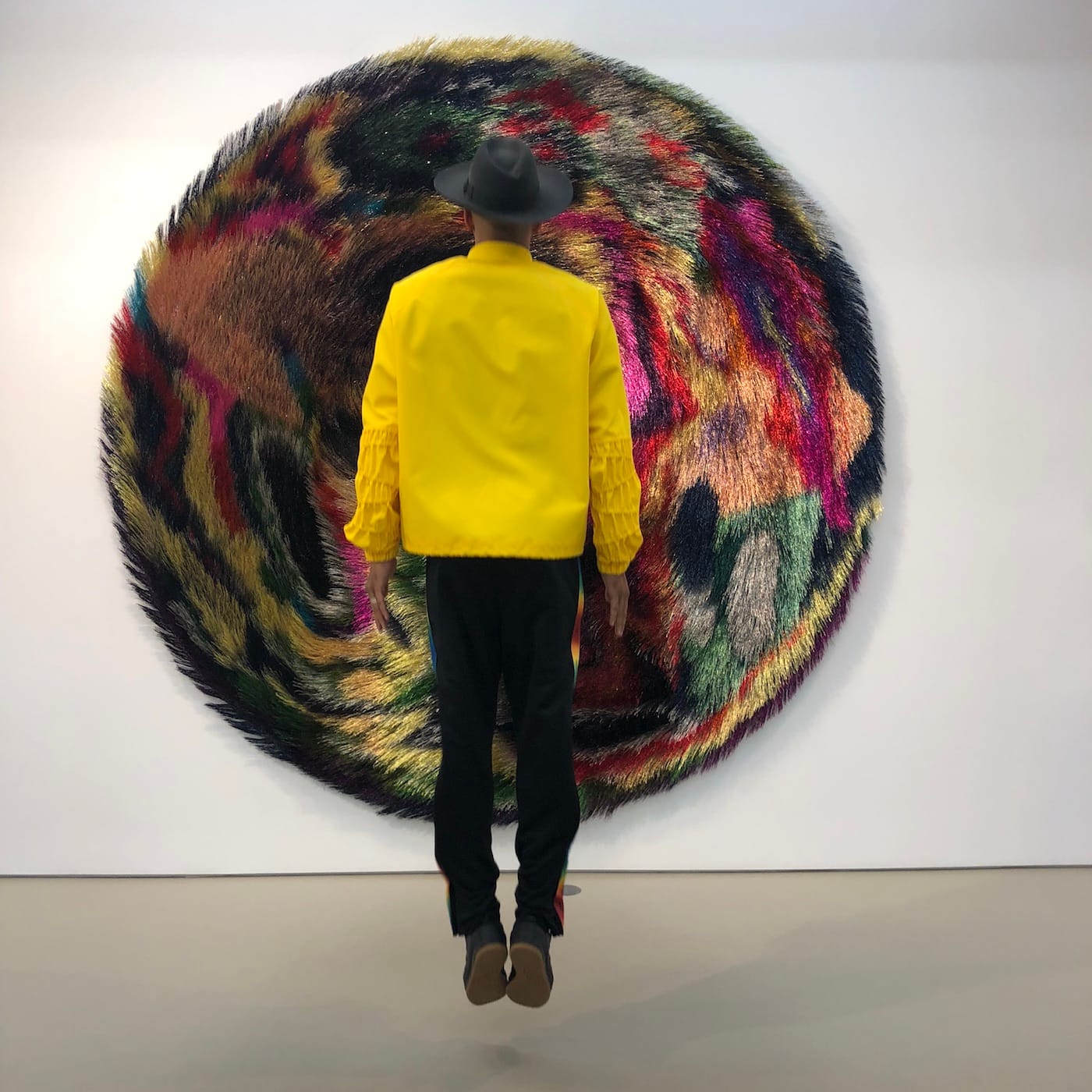 Swizz Beatz in front of a work from Nick Cave's <em>Tondo</em> series (photo courtesy the Dean Collection)