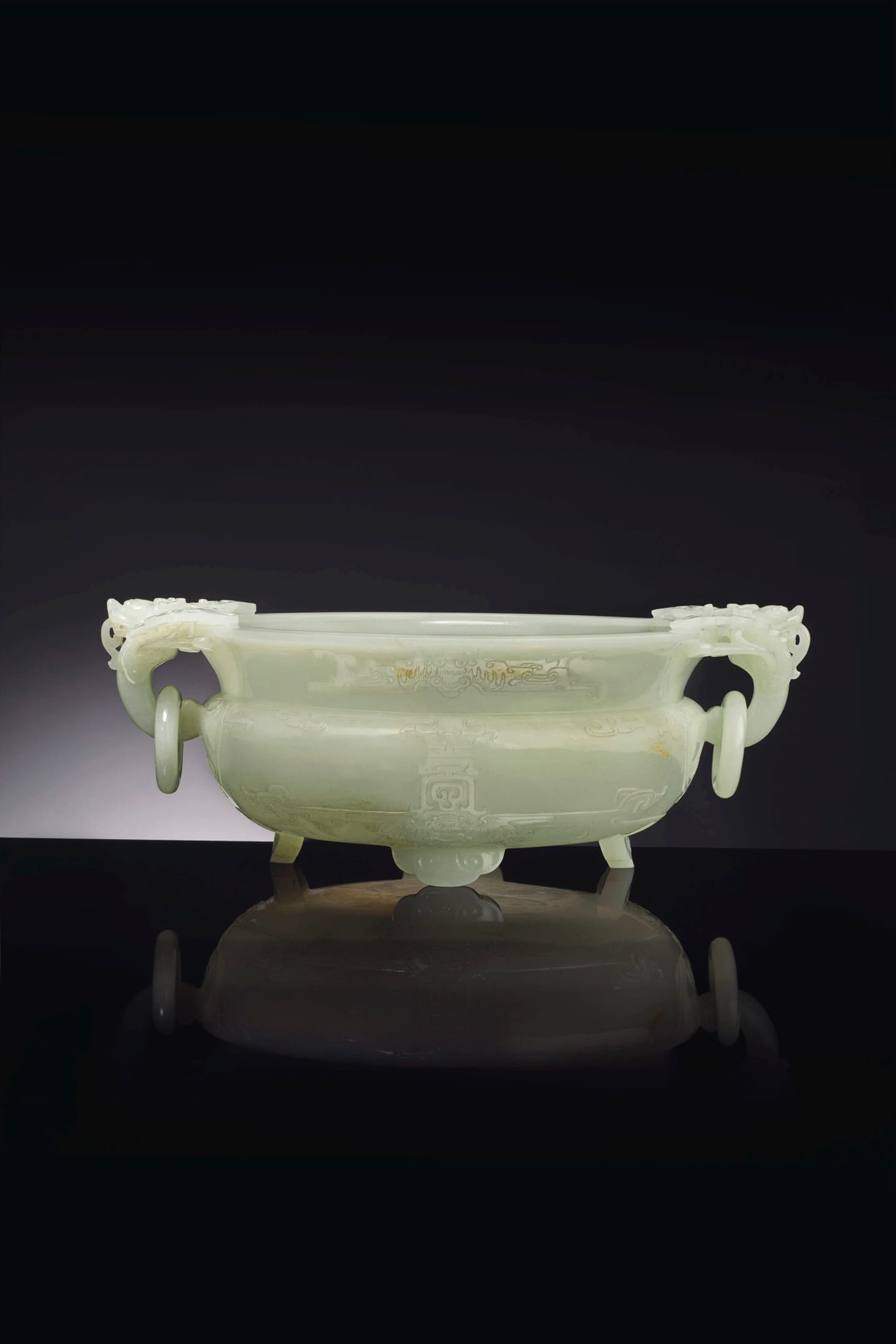 A well-carved white jade marriage bowl, Qianlong Period (1736-1795), 10 ¼ inches wide across handles, zitan stand (image courtesy Christie's)
