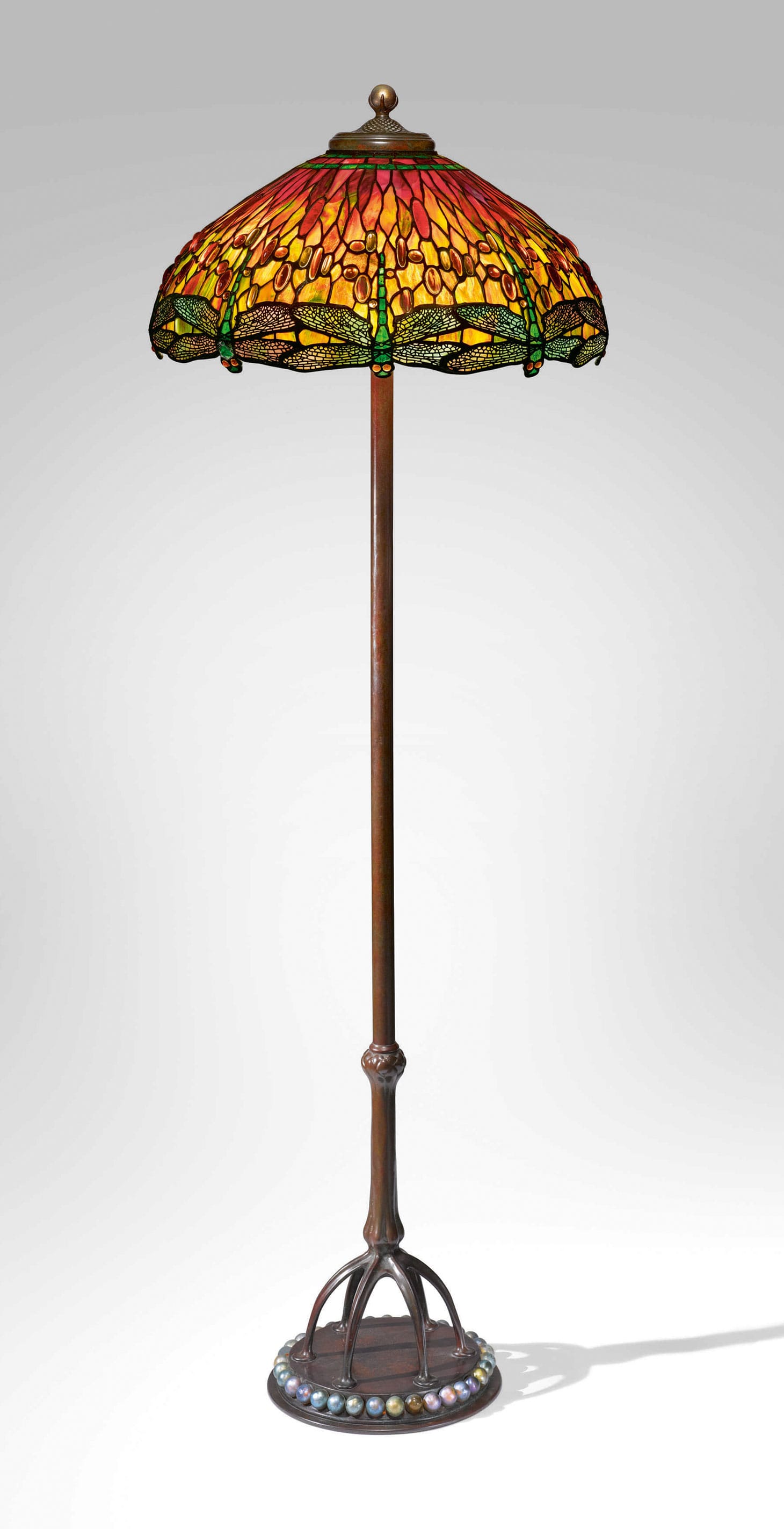 Tiffany Studios, an important "Dragonfly" floor lamp (c. 1910), with a rare "Ball" base and finial shade, leaded glass, favrile glass, patinated bronze, 63 3/4 inches high, 22 1/2 inches diameter of shade (image courtesy Sotheby's)