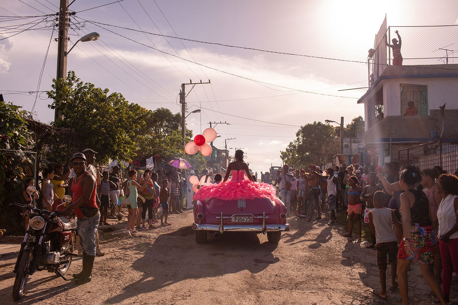 Diana Markosian, "The Cubanitas" (2018): Pura rides around her neighborhood in a pink 1950s convertible, as the community gathers to celebrate her 15th birthday, in Havana, Cuba (© Diana Markosian, Magnum Photos)