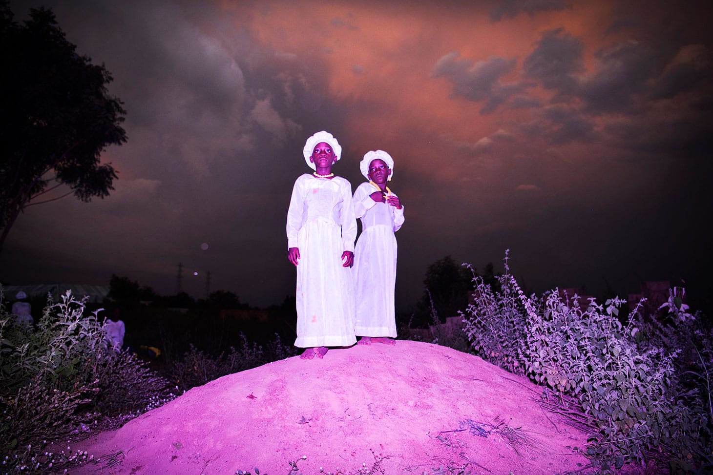 Bénédicte Kurzen, Noor and Sanne de Wilde, Noor, "Land of Ibeji" (2018): Dressed for church, Kehinde Deborah and Taiwo Celestine (10) stand on a hill near Igbo-Ora, Nigeria (© Bénédicte Kurzen, Noor and Sanne de Wilde, Noor)