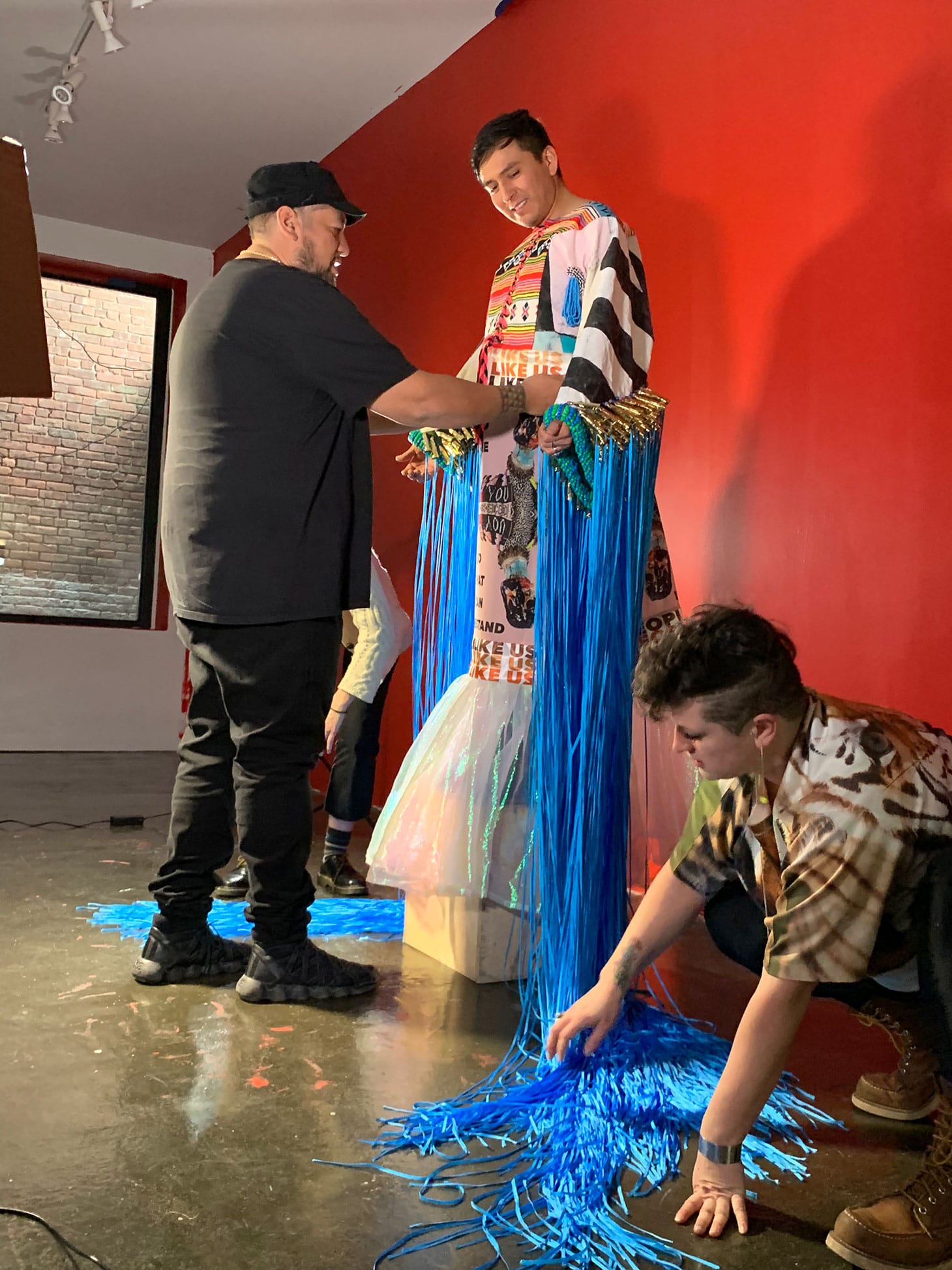 Demian DinéYazhi´ modeling Jeffrey Gibson's tunic