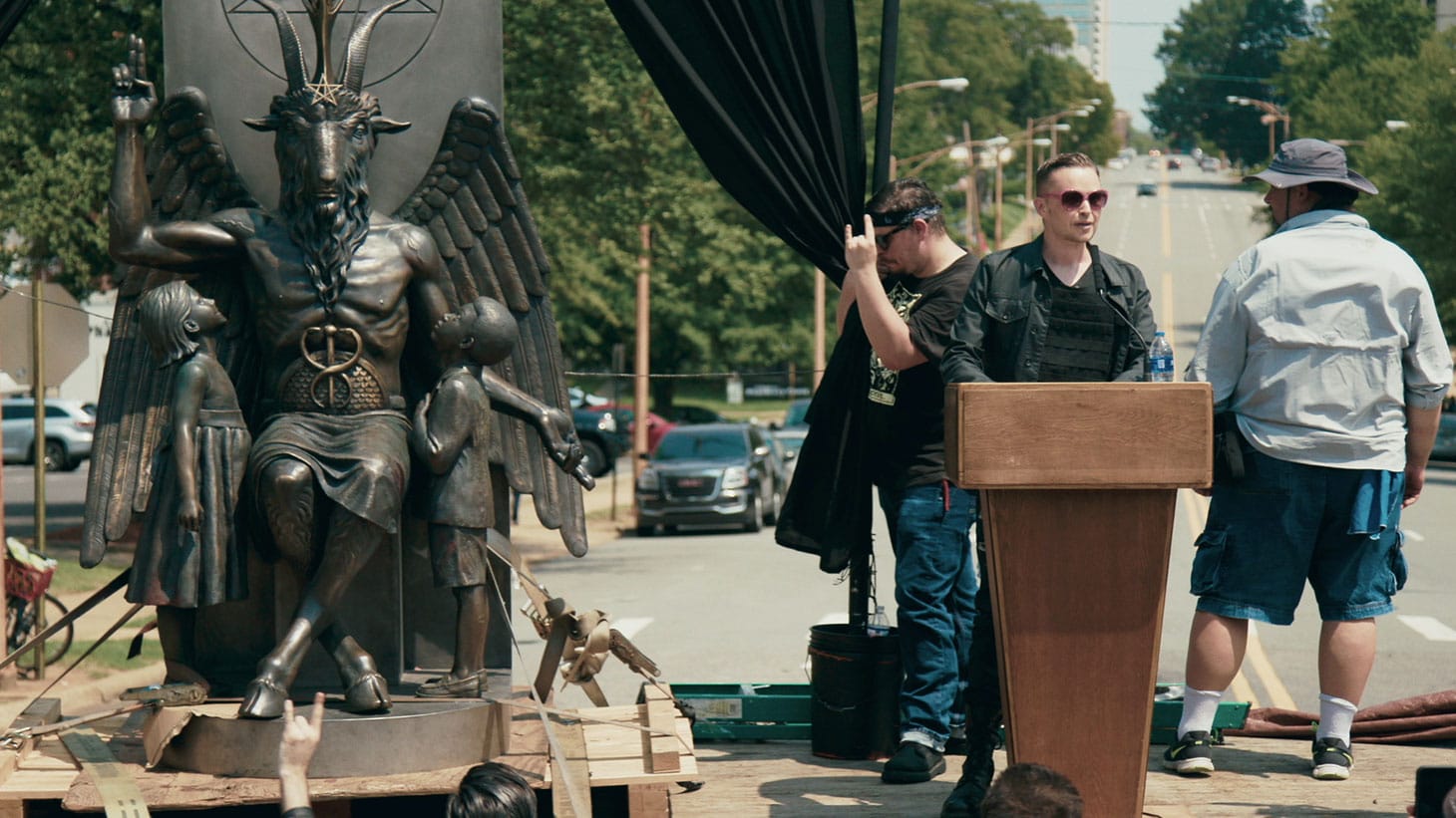 Lucien Greaves delivering a speech in front of the state capitol building in Little Rock, AR in <em/>Hail Satan?, a Magnolia Pictures release