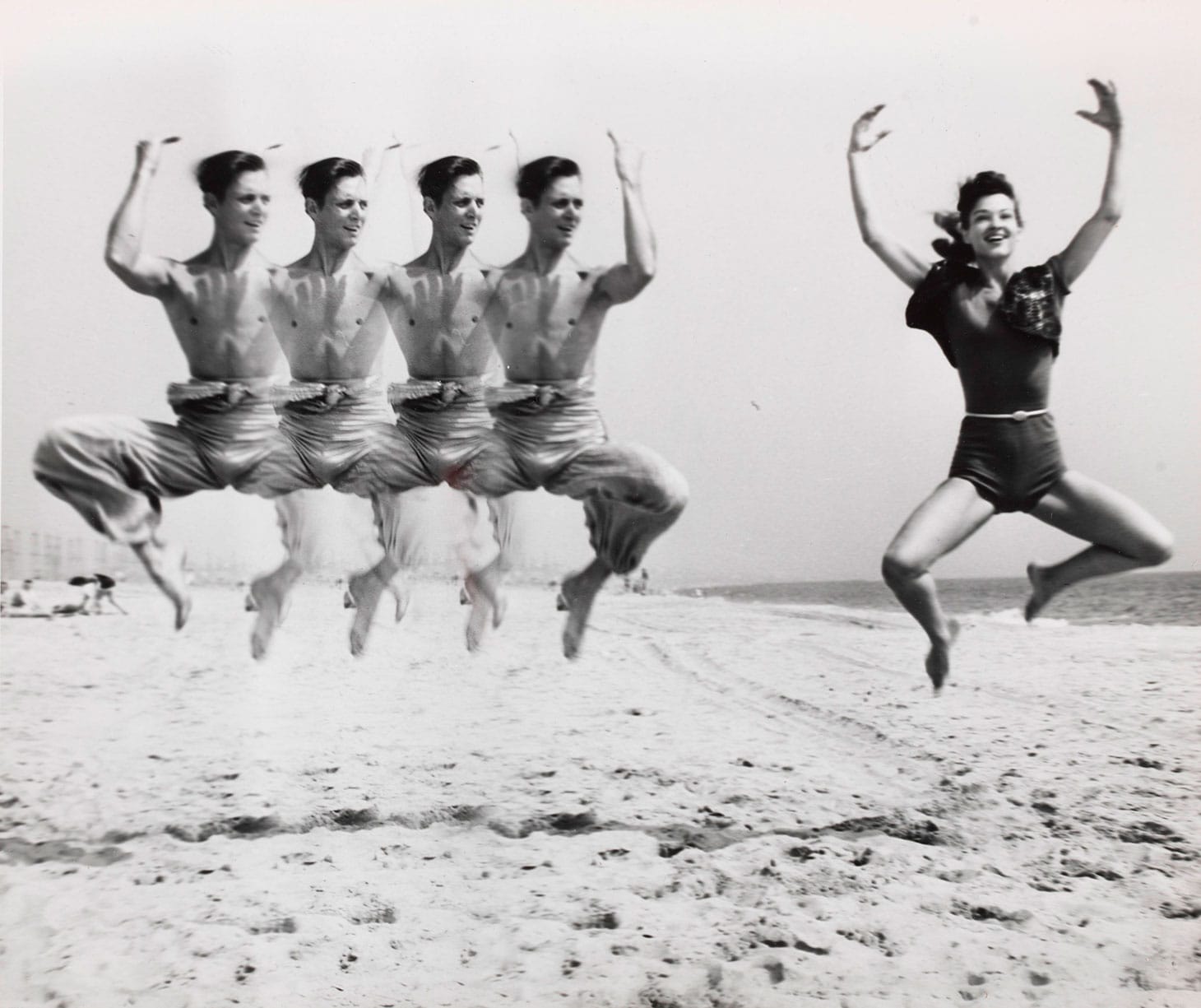 Weegee, "Jumping on Beach" (c. 1955), gelatin silver print, image: 7 3/4 x 9 1/2 inches, sheet: 8 1/4 x 10 inches (image courtesy Christie's)