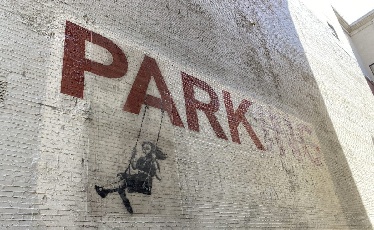 The Real Story Behind Banksy's “Parking” Mural in LA The Real Story Behind Banksy's “Parking” Mural in LA