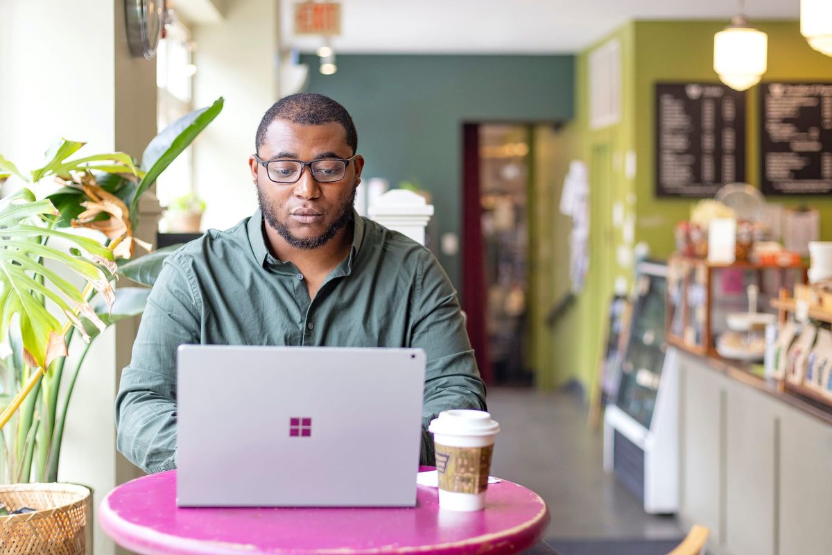 TK Smith, winner of the 2024 Rabkin Prize, working in a cafe (photo by Kevin J. Miyazaki)