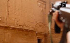 Using a rifle to destroy a sculpture