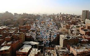 Artist Transforms Buildings in Cairo’s “Garbage City” with Massive Calligraphic Message