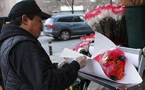 Wrapping Flowers in Paper that Points Out Their Human Cost