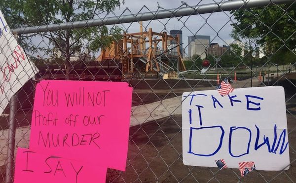 Protest signs on the fence near Sam Durant's "Scaffold" (2012) in the Minneapolis Sculpture Garden