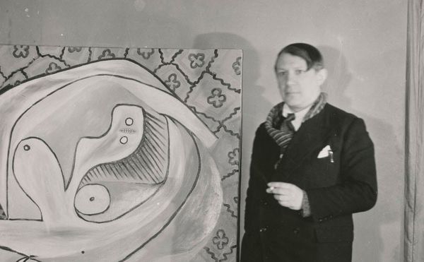 Anonymous, "Pablo Picasso in front of the oil on canvas “'Le Repos' at the Georges Petit Gallery" (1932), gelatin silver prin