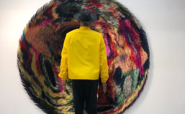 Swizz Beatz in front of a work from Nick Cave's Tondo series (photo courtesy the Dean Collection)
