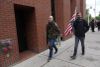 A man carries an assault rifle during protests in Spokane in June.