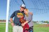 Travis and Erika Holmes look out over the soccer field where their son, Hunter Holmes, once played as the Redmond High