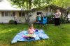 As her 2-year-old Zoey enjoys a picture book, Jessica Heavner throws a Frisbee with her son Joseph, 3, and daughter Alexia,