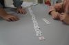 An elementary school student who needs extra help learning to read uses letter tiles with Ronda Fritz, a professor at