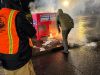 Officials douse the flames after an incendiary device was placed in a ballot box in Vancouver, Wash., in November 2024.