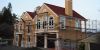 New House construction with romantic florishes and details, curved windows, dormers, eagle wind vane, North Matthews Beach,