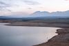 A prescribed burn on National Forest land sends smoke along Lloyd’s Lake. The reservoir, which provides residential water to