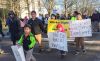 Demonstrators march around the Oregon Capitol Saturday, Jan. 14, 2017, in opposition to President-elect Donald Trump's
