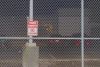 A ‘no trespassing’ sign on a fence outside the Northwest Detention Center.