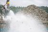 Using a hose, Adam Kravitz transplants oysters from one area to another in Mud Bay near Olympia, Washington, at one of