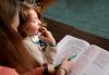 Sara Schultz reading with her son Keith Schultz-Davis, 7, at their home in Northeast Portland on Dec. 14, 2022. Keith has