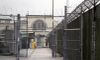 In this Jan. 28, 2016, file photo, a man does maintenance work between razor wire-topped fences at the Monroe Correctional