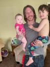Tim Riley is seen holding his children. Riley is one of four people who have died in the custody of Canyon County Jail since