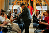 A TriMet fare inspector checks a passenger's fare on a MAX train. Photo courtesy of the Portland Tribune.