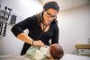 In this Tuesday, Aug. 13, 2019, photo, Dr. Jasmine Saavedra, a pediatrician at Esperanza Health Centers whose parents