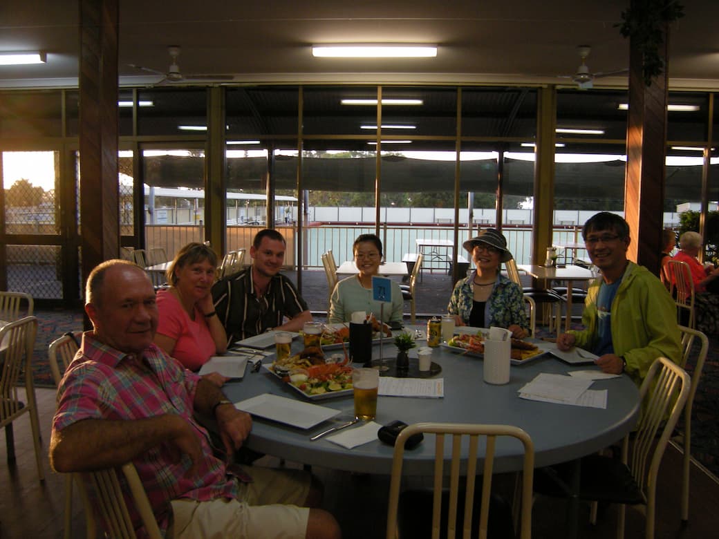 Six people sitting at a dining table_HomeExchange