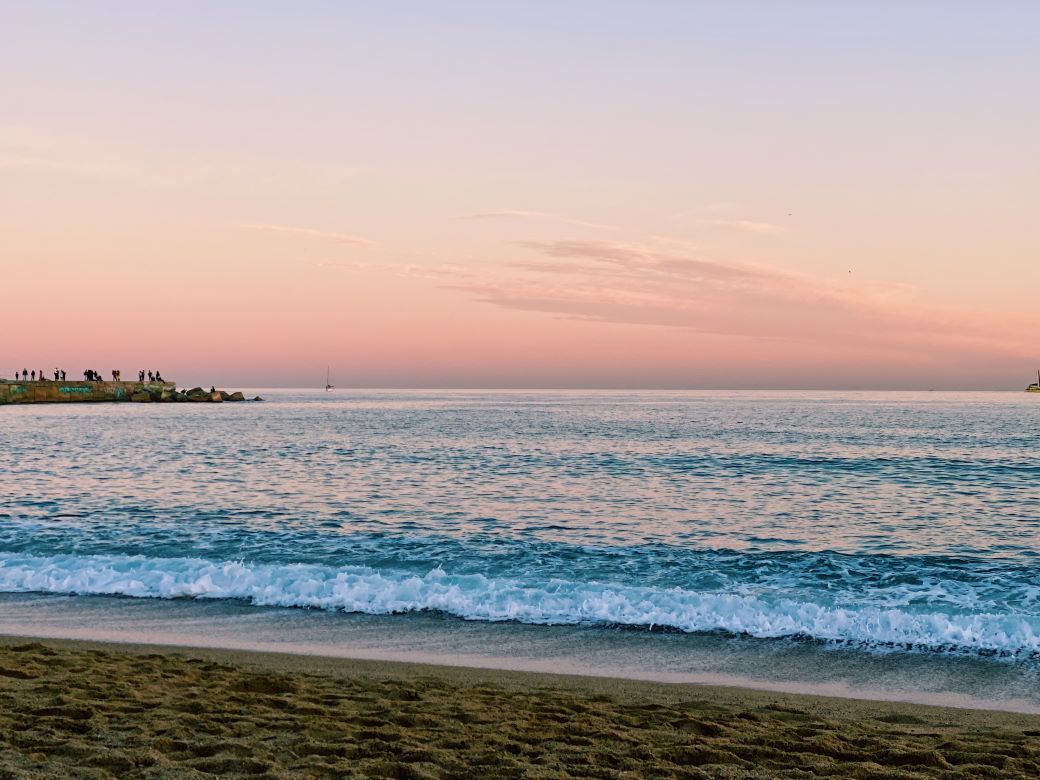 Sand and surf at sunset in Barcelona - best beaches in Spain
