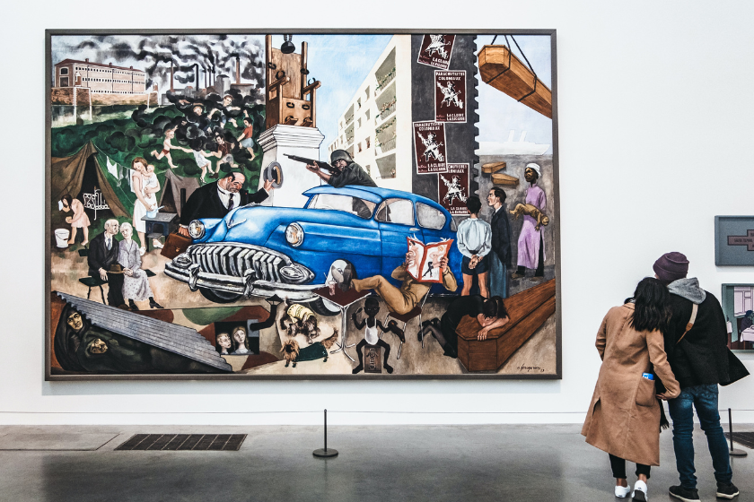Couple standing in front of a blue car painting at the Tate Modern. Best things to do in London on a rainy day.