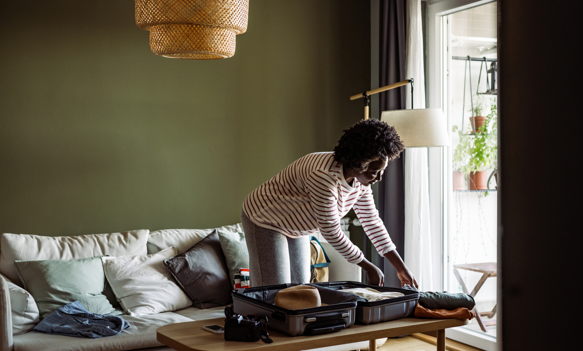 Woman packing her bag for her next home exchange