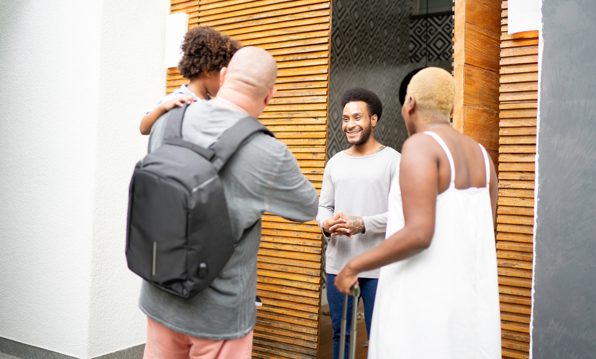 Host welcoming guests in his home
