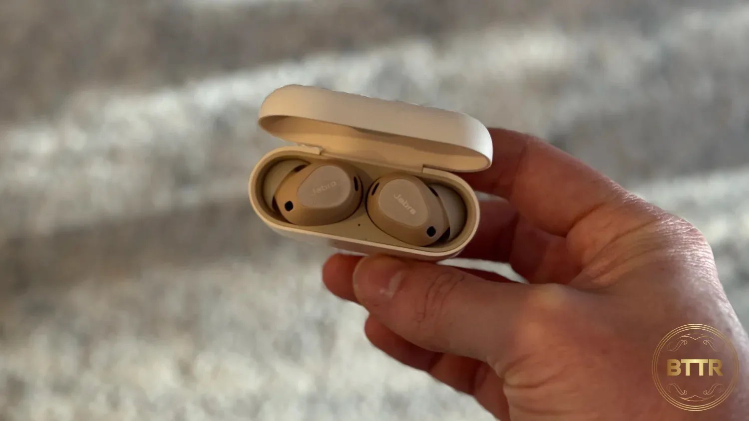 Another photo of me holding the earbuds in the case