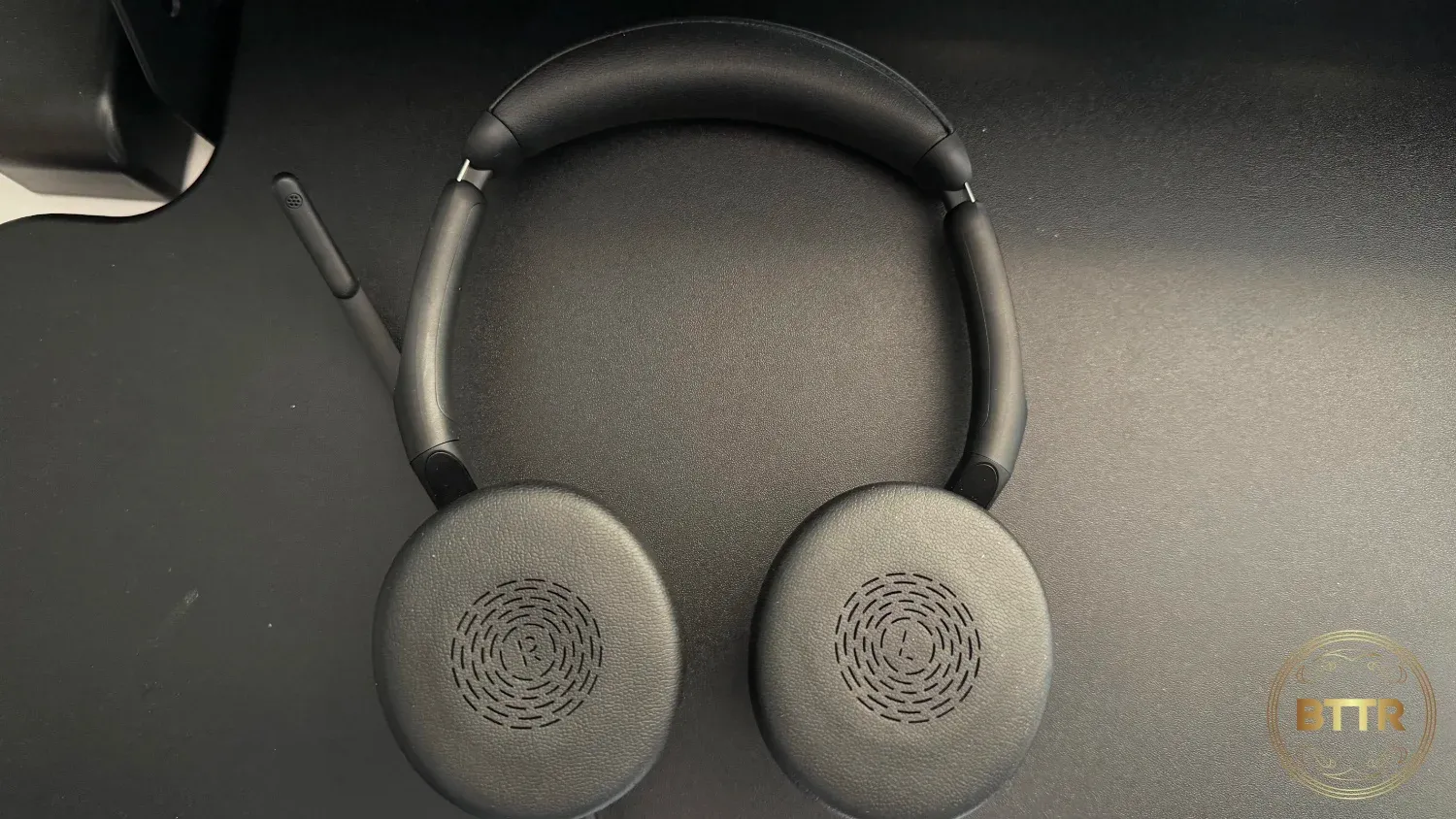 The headphones lying flat, cushion side up