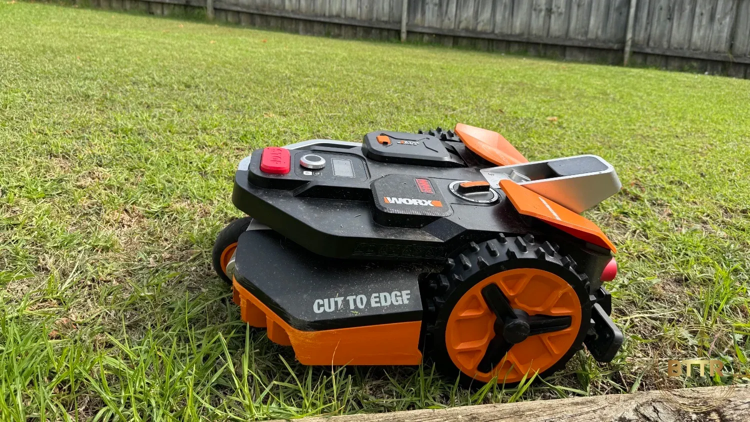 The Landroid Vision cutting along the edge of a garden