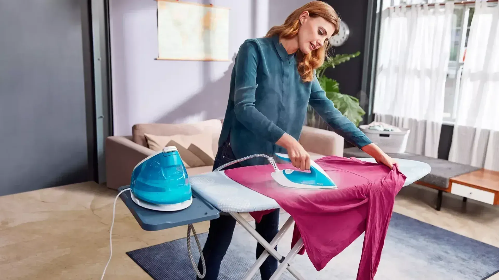 A woman ironing a shirt with a steam iron