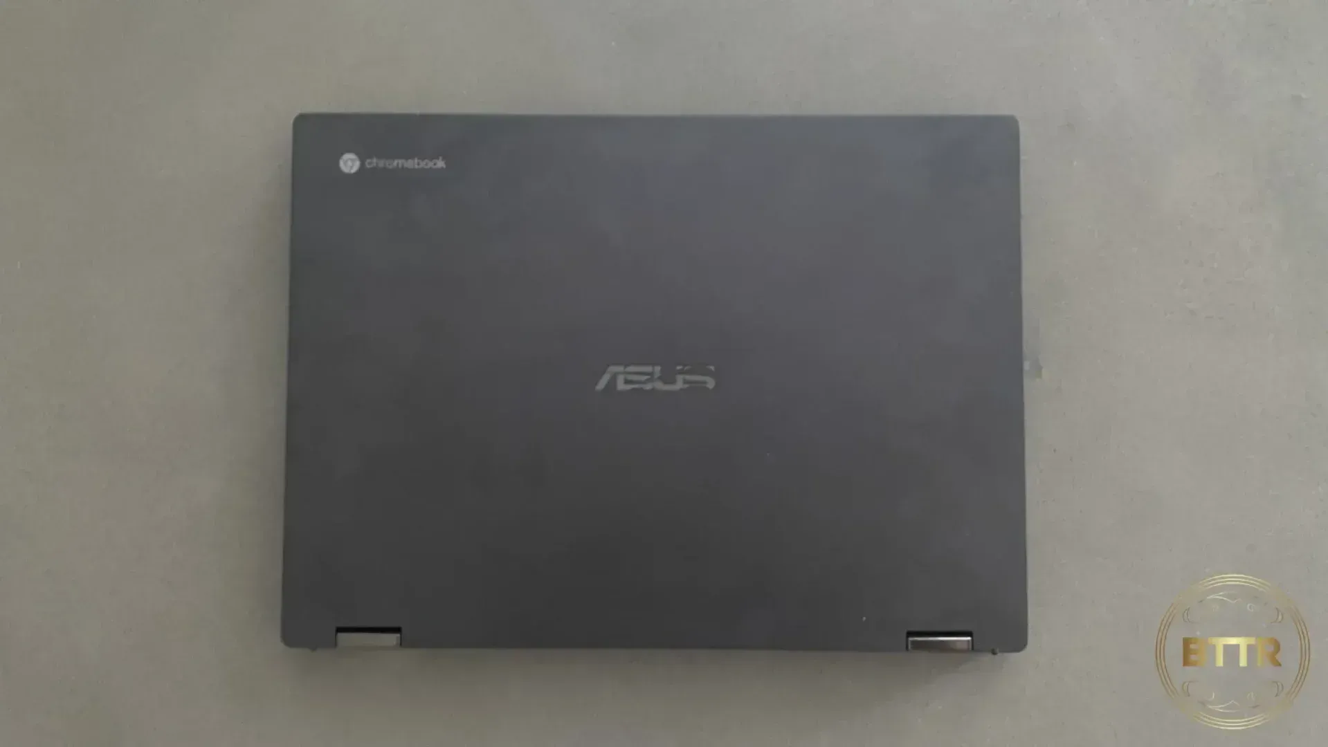 Looking straight down at the ASUS Chromebook Flip CX5 closed on a coffee table