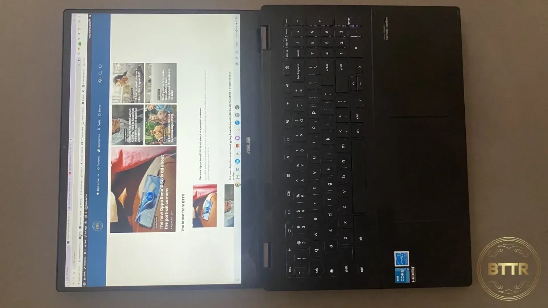 The ASUS CX5 lying flat on a coffee table with the screen open and horizontal